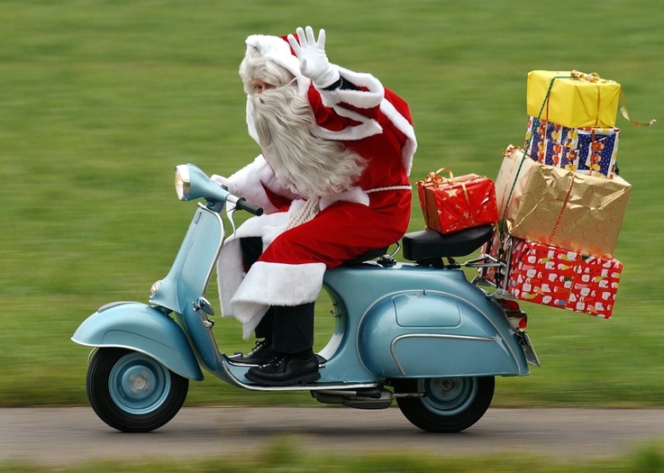 
								A Santa Claus races on a vintage vespa bike to deliver presents
							